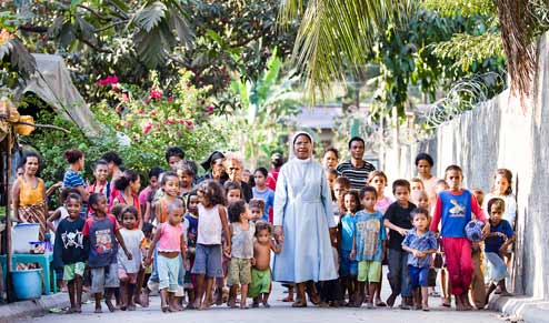 Sister Guilhermina Marcal walking with displaced children in Timor-Leste