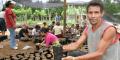 Honduras. Local villager holding potted fruit plant