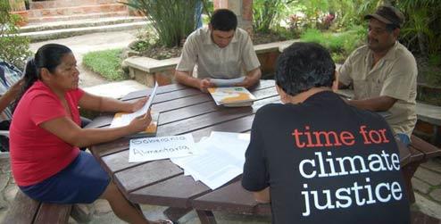 Time for Climate Justice campaigners sit around the table