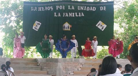 Children dancing a folkloric dance on stage for parents, teachers, and fellow pupils Children dancing a folkloric dance on stage for parents, teachers, and fellow pupils