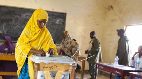 Woman places vote in ballot box, Somaliland Woman places vote in ballot box, Somaliland